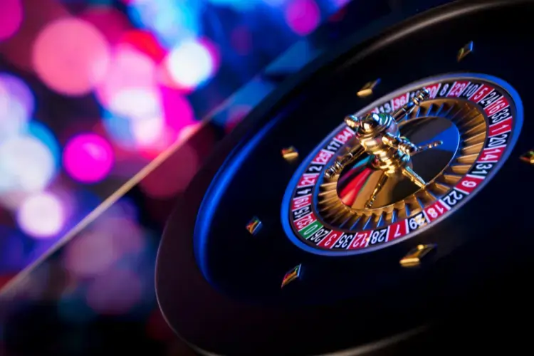 Close-up view of a casino roulette with luminous blur effect in the background